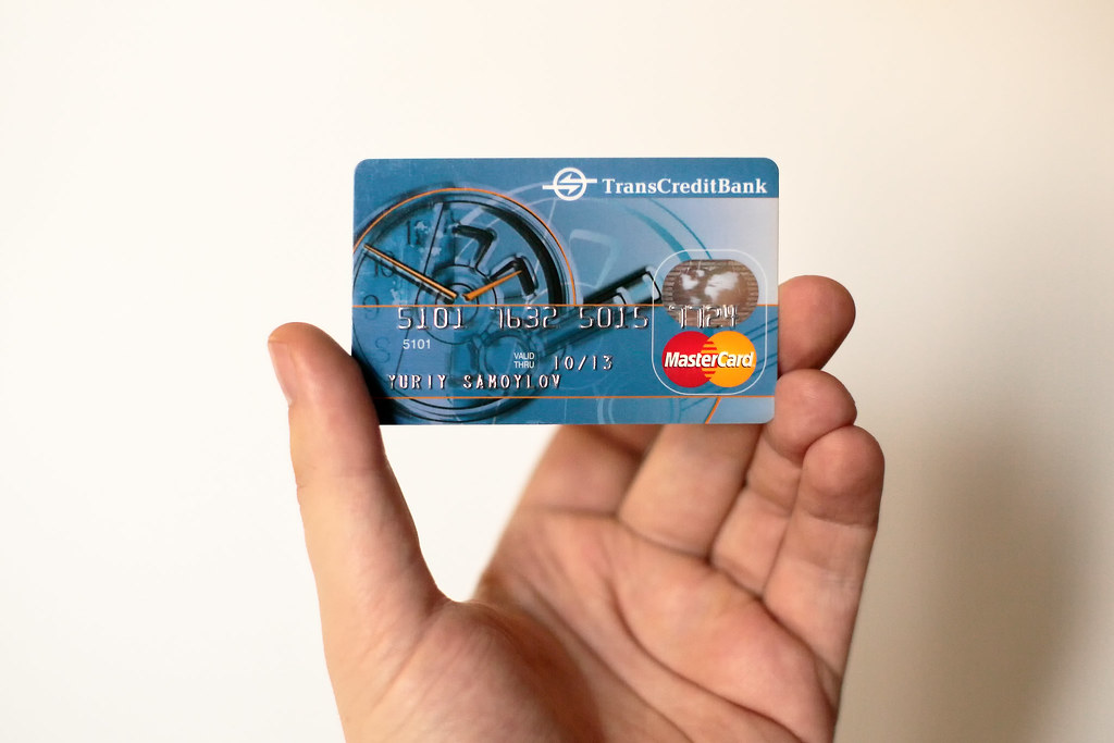 Member reviewing a payment card while working at a computer